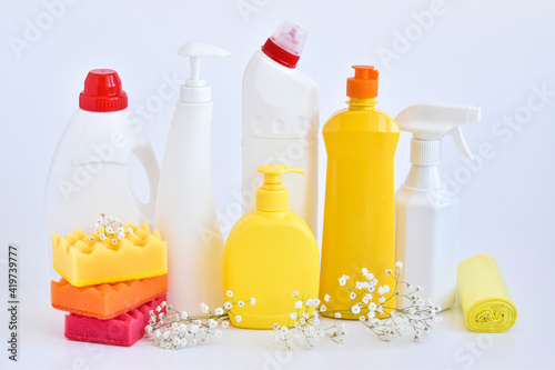 Cleaning products on white. Bottles of detergent and sponges. The concept of cleaning in the house, apartment, office. Household chemicals.