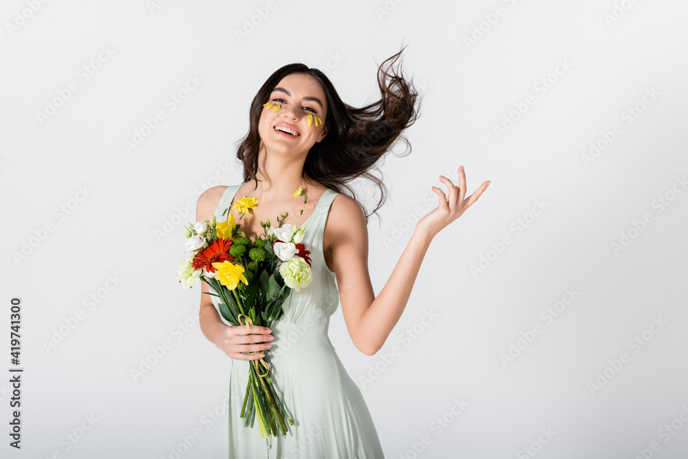 cheerful young woman with petals on face holding bouquet of flowers isolated on white cheerful young woman with petals on face holding bouquet of flowers isolated on white