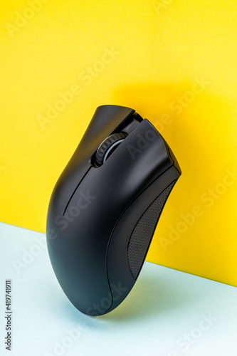 modern gaming mouse device on abstract creative background. computer mouse hardware. cybergaming accessory photo