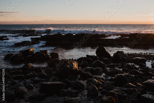 West coast sunrise at the stone filled beach photo