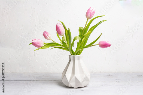 Fototapeta Naklejka Na Ścianę i Meble -  Bouquet of gentle pink tulips in ceramic vase on white background