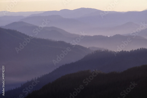 Rogue River valley in early morning with fog and mist in the valley. Oregon. Photographed on Fujichrome film with Nikon F4 35-mm camera.