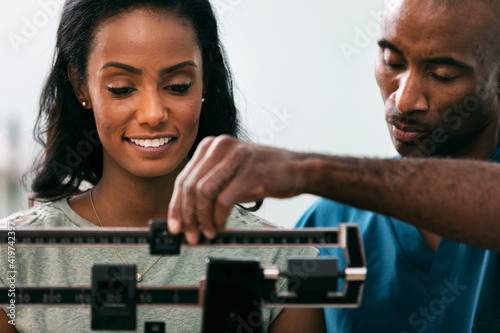 Exam: Woman Has Weight Checked During Exam
