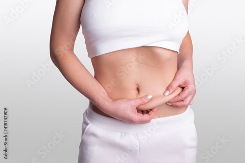 A woman using pinch test as one of the methods for measuring body fat