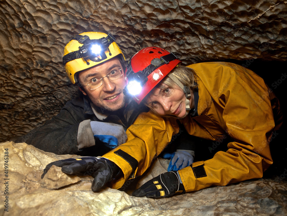 Adventurous middle age couple exploring cave on Vancouver Island. British Columbia. Canada 