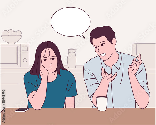 The man and woman at the table are having a conversation, and the woman is looking bored.