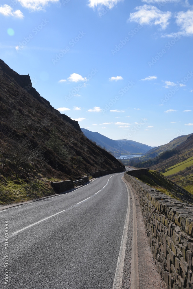 a steep and dangerous road near Cadair Idris with mountains either side and tal-y-llyn lake in the background