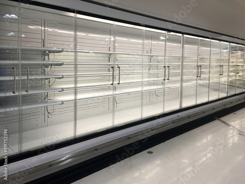 Photography Row of empty commercial fridges at grocery store