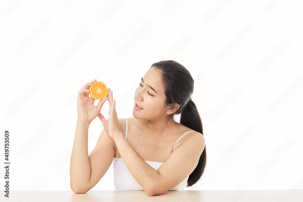 woman with sliced orange on white woman with sliced orange on white