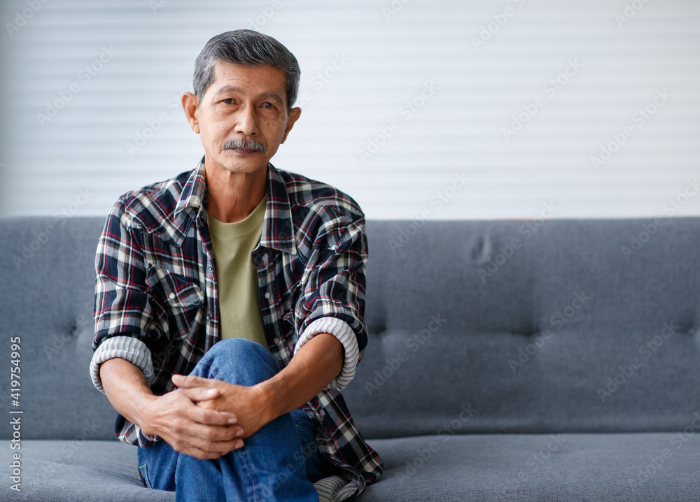 Fototapeta premium Portrait of senior old Asian man with grey hair and beards sitting relax on sofa with happy and calm face