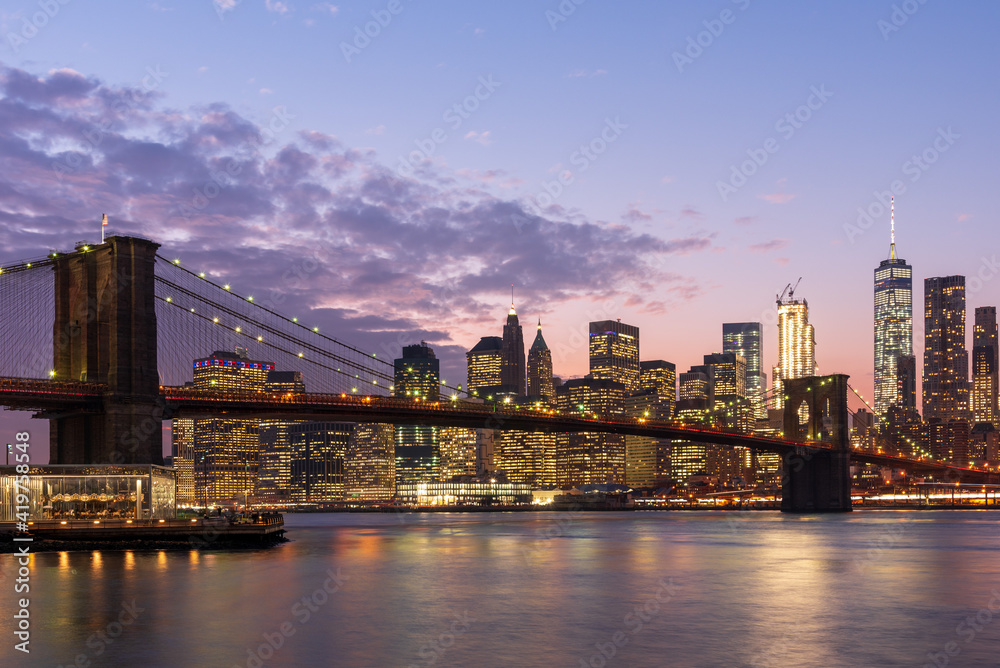 Magic hour view of Manhattan Skyscrapers and Brooklyn bridge in New York, USA