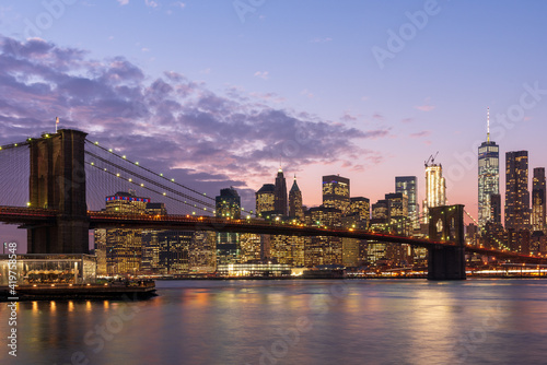 Magic hour view of Manhattan Skyscrapers and Brooklyn bridge in New York, USA © hit1912