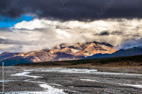 dramatic autumn landscape photo of he mountain peaks and valleys inside the Denali National Park in Alaska