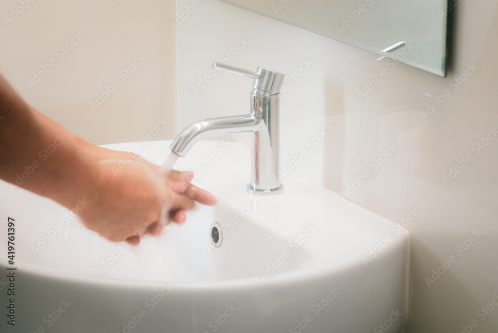Soft focus of hands are joined together And catch the water from the faucet to wash hands, Concept of protection or prevention coronavirus or Covid19 by washing or cleaning hands frequently. Soft focus of hands are joined together And catch the water from the faucet to wash hands, Concept of protection or prevention coronavirus or Covid19 by washing or cleaning hands frequently.