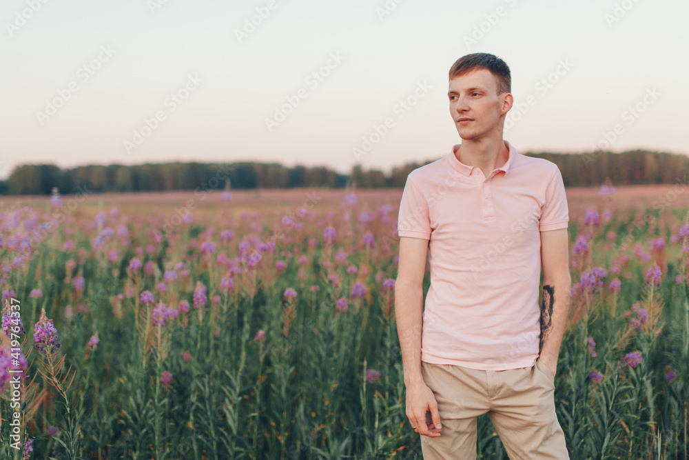 a man walks through a flower meadow. Love and spring blooming a man walks through a flower meadow. Love and spring blooming