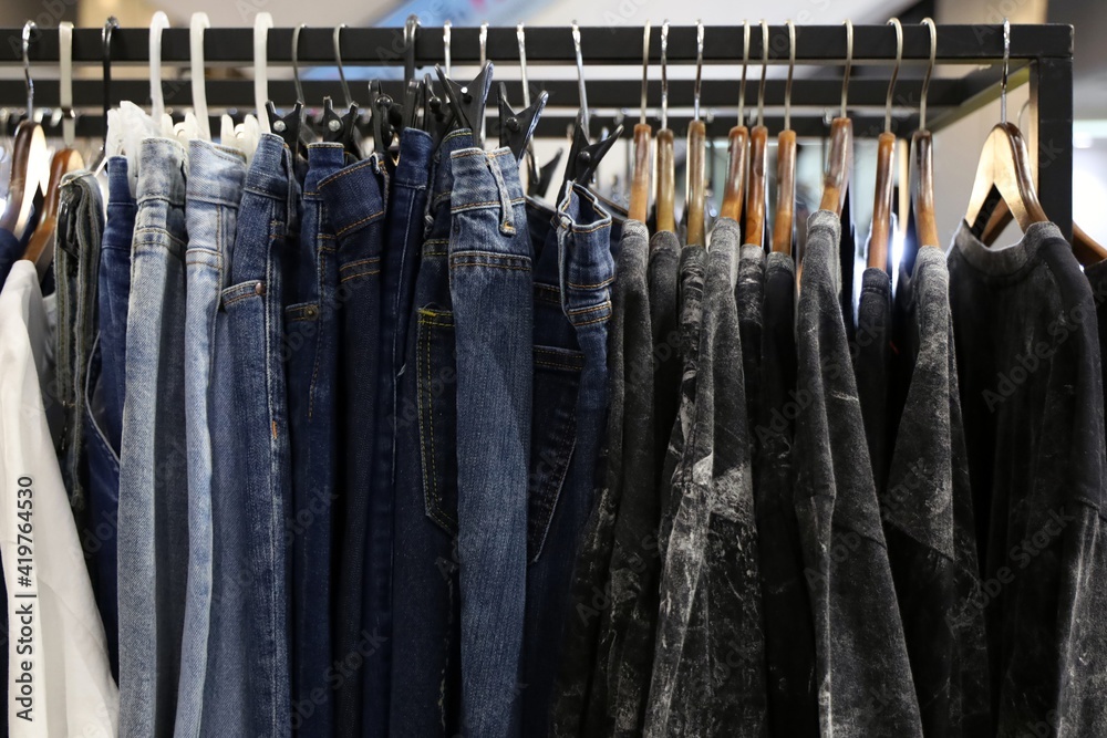 Jeans, t-shirts and casual shirts are hanging on the clothesline in a shopping mall. Jeans, t-shirts and casual shirts are hanging on the clothesline in a shopping mall.