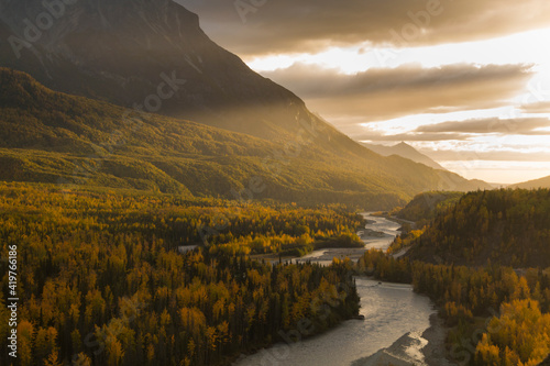 dramatic autumn sunset by the mountain range in Matanuska River in Alaska.