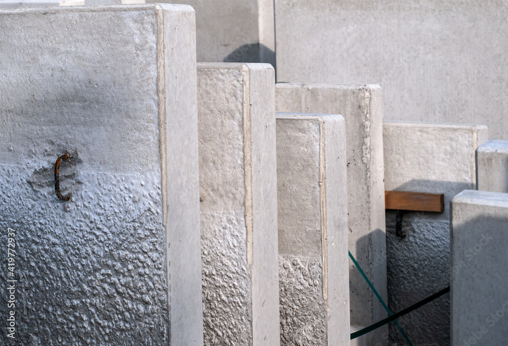 a row of gray concrete elements in sunlight