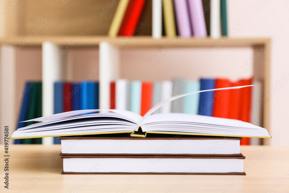 Stack of books on table in room Stack of books on table in room