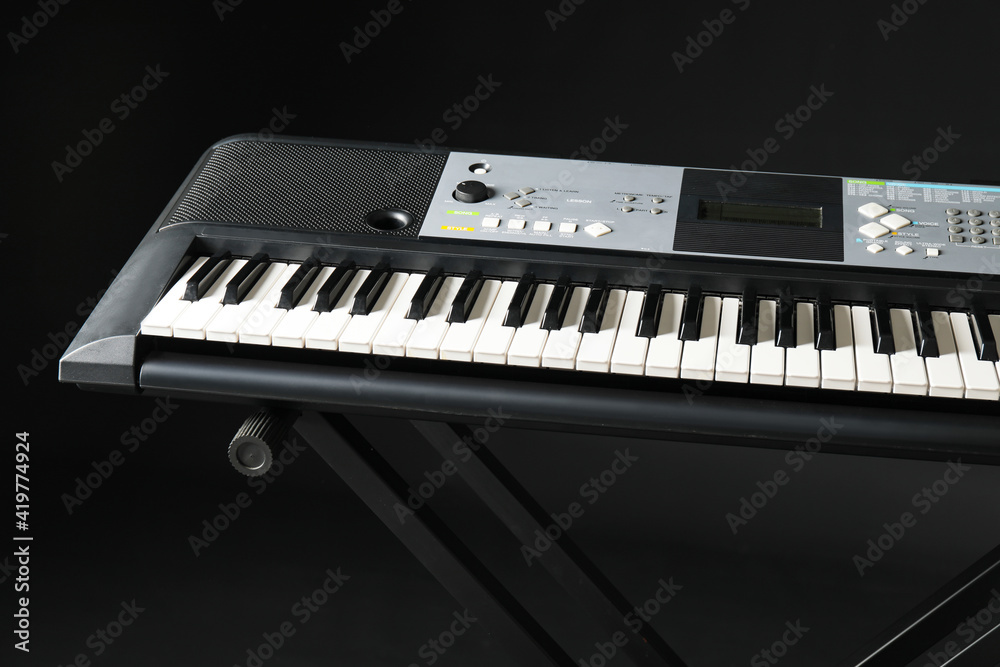 Fototapeta premium Stylish synthesizer on dark background, closeup