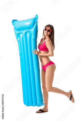 Beautiful young woman with inflatable mattress on white background © Pixel-Shot