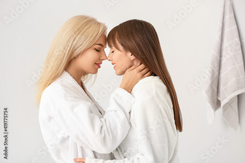 Happy lesbian couple in bathroom