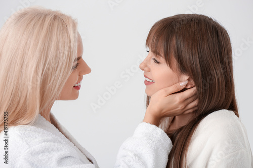 Happy lesbian couple in bat...