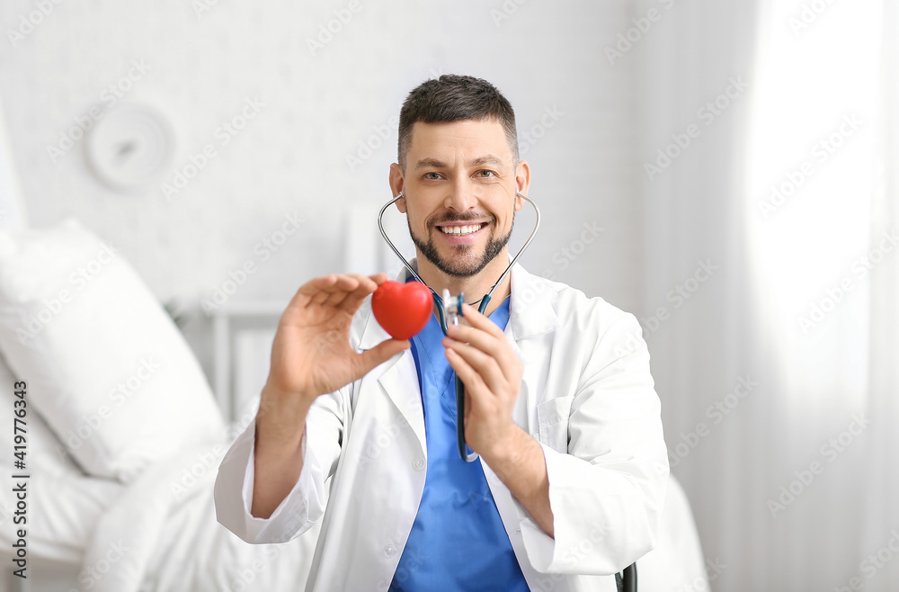 Cardiologist with red heart and stethoscope in clinic Cardiologist with red heart and stethoscope in clinic