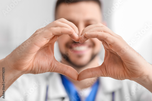 Cardiologist making heart w...