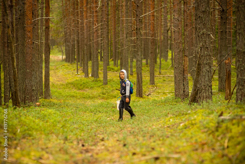boy 8-10 years old in a pine forest, selective focus