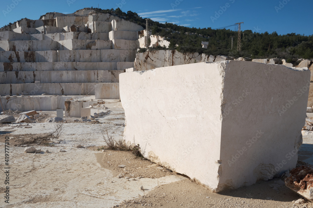 Mining of stone material. Cut marble block lays on ground at marble quarry. Mersin province, Turkey Mining of stone material. Cut marble block lays on ground at marble quarry. Mersin province, Turkey