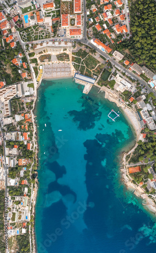 Aerial overhead drone shot of sunset beach in Dubrovnik by Dalmatia coastline in Croatia summer