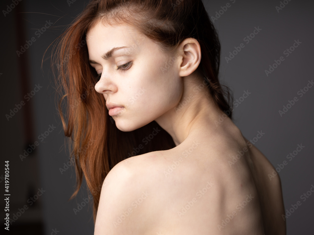 Pretty woman model red hair gray background portrait close-up beautiful face Pretty woman model red hair gray background portrait close-up beautiful face