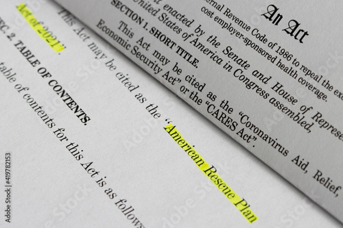 Closeup of the documents of both the Cares Act (Coronavirus Aid, Relief, and Economic Security Act) and the American Rescue Plan Act of 2021. photo