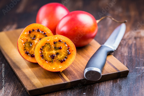 Organic tamarillo (tree tomato) on cutting board photo