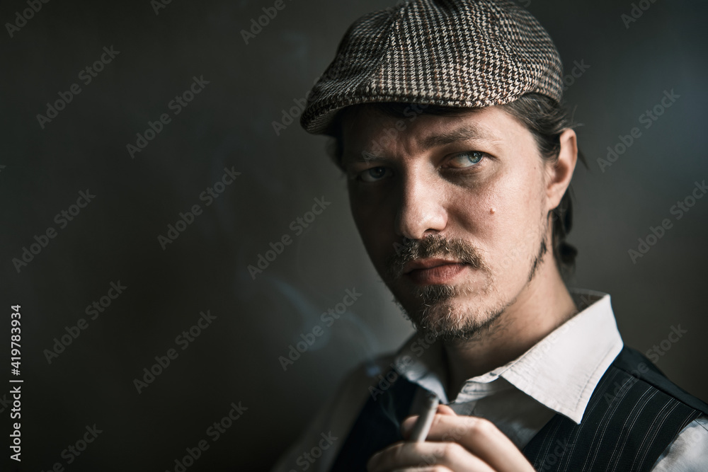 Young guy smoke a cigarette, dressed in a retro style Young guy smoke a cigarette, dressed in a retro style