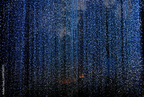 Defocused of lights curtain backdrop decoration with blue shine beautiful background © louisnina
