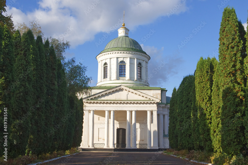 All Saints church in Nizhyn, Chernihivska oblast, Ukraine. Beautiful old building XVIII century with dome for religious purposes, Orthodox Church. Ukrainian baroque architecture. Shady alley. Scenery.