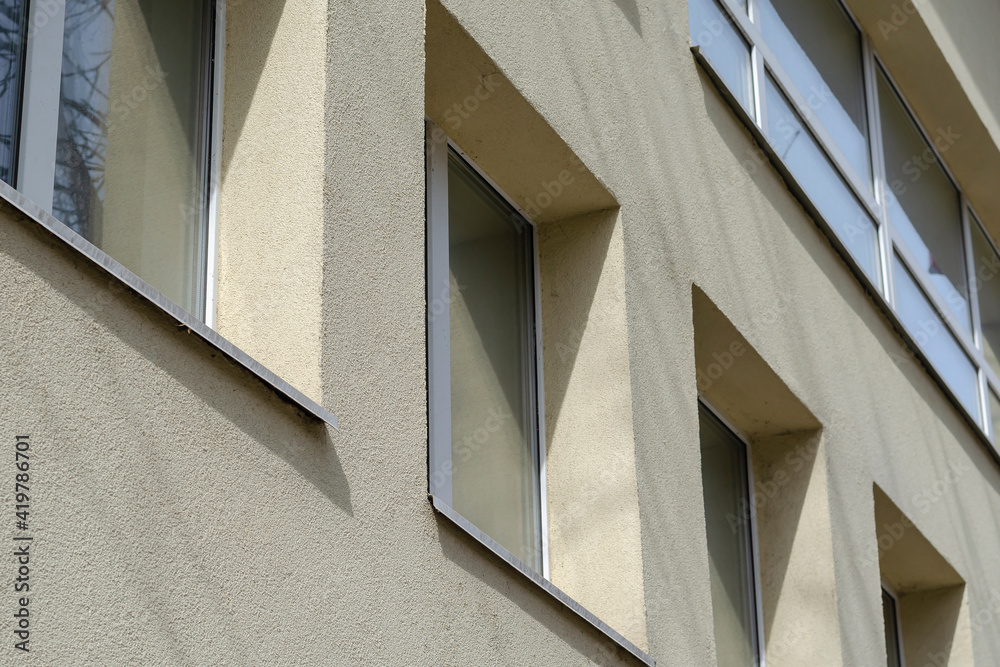 Facade of a yellow building with windows. Facade of a yellow building with windows.