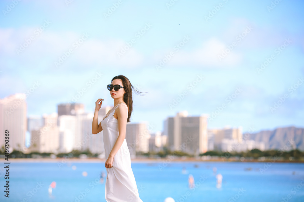 Girl wearing white long dress by the sea, Honolulu, Oahu, Hawaii Girl wearing white long dress by the sea, Honolulu, Oahu, Hawaii