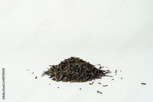 Dry black tea leaves on white back ground. Tea leaves isolated. photo