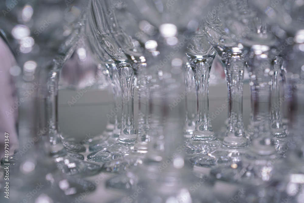 glasses stand in a row and glare in the light at a cocktail party glasses stand in a row and glare in the light at a cocktail party