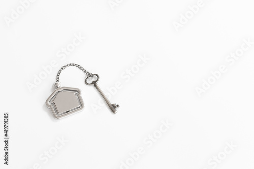 Home key with house keychain on white background