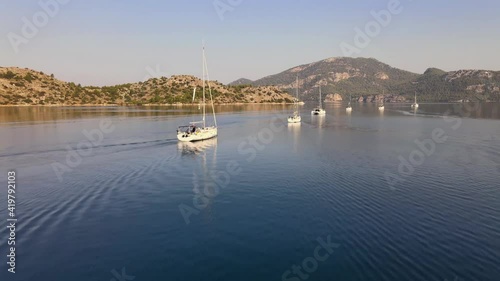 4K Aerial Video Of Sailing Yachts Floating In Line In Sea Strait  photo