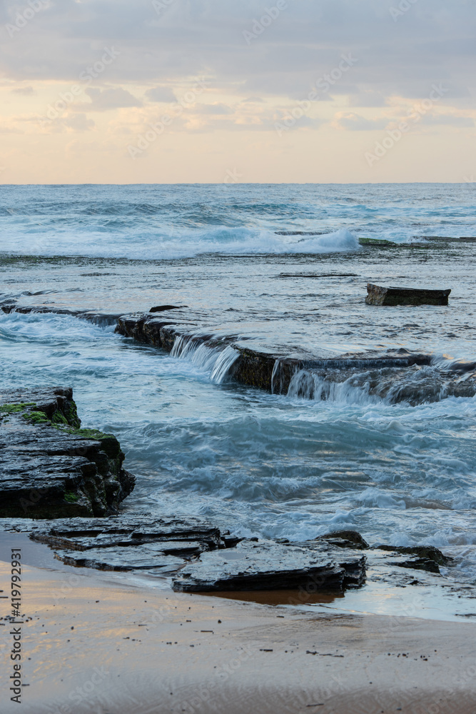 High tide sea water between rock shelf on the coastline.