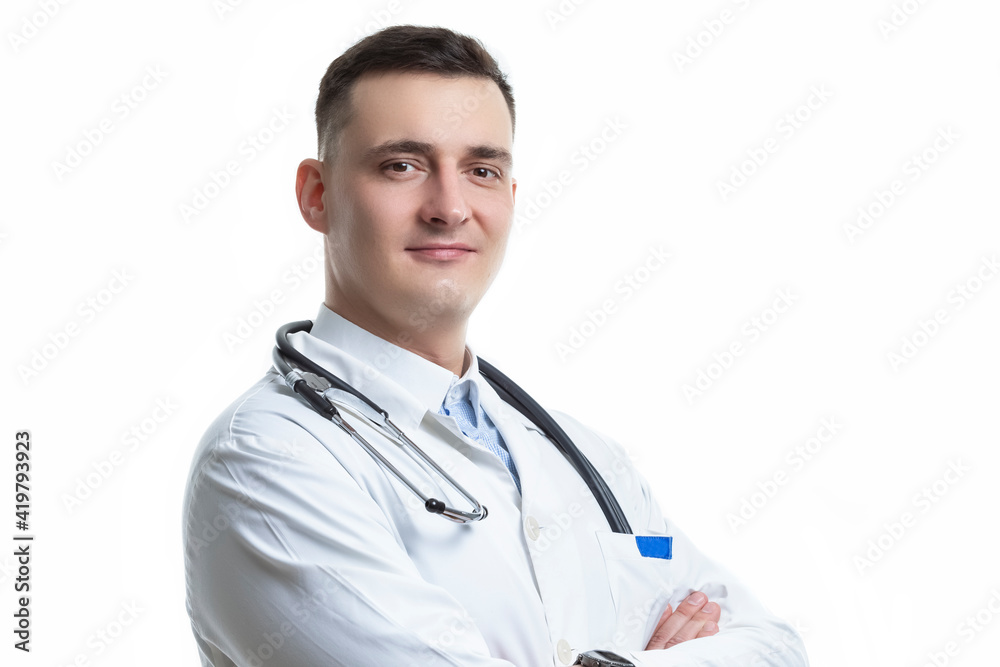 Medical Concepts. Closeup Portrait of Professional Confident Male GP Doctor Posing in Doctor's Smock With Endoscope and Hands Folded on White Background. Medical Concepts. Closeup Portrait of Professional Confident Male GP Doctor Posing in Doctor's Smock With Endoscope and Hands Folded on White Background.