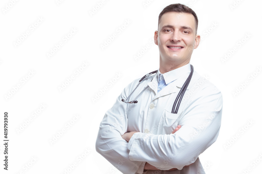 Medical Concepts. Portrait of Smiling Professional Mature GP Doctor Posing in Doctor's Smock With Endoscope and Folded Hands on White Background. Medical Concepts. Portrait of Smiling Professional Mature GP Doctor Posing in Doctor's Smock With Endoscope and Folded Hands on White Background.