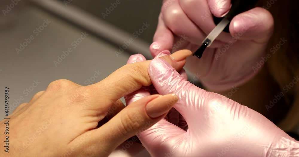 Manicure artist making nail polishing with brush and tools. Manicure artist making nail polishing with brush and tools.