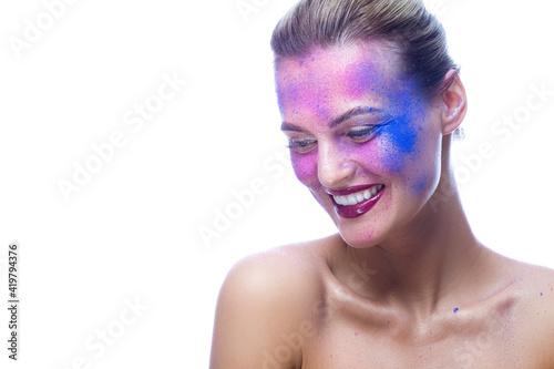 Macro Beauty Portrait of Caucaisan Female With Powder Colorful Artistic Makeup Across The Face On White. photo