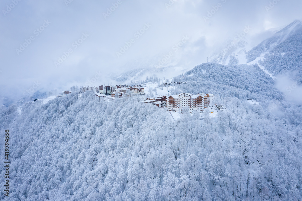 Winter aerial view of the Ski Resort Rosa Khutor. A complex of hotels on the site of the former Olympic village of Rosa Plateau at an altitude of 1170 m from sea level. Krasnaya Polyana, Sochi, Russia